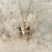 A gold chain necklace with a gold butterfly pendant.