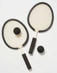 On a white background is two rackets with two balls.