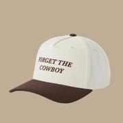 A white and brown two-toned snapback that reads, "Forget The Cowboy".