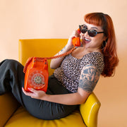 A black pair of cat-eye shaped sunglasses.