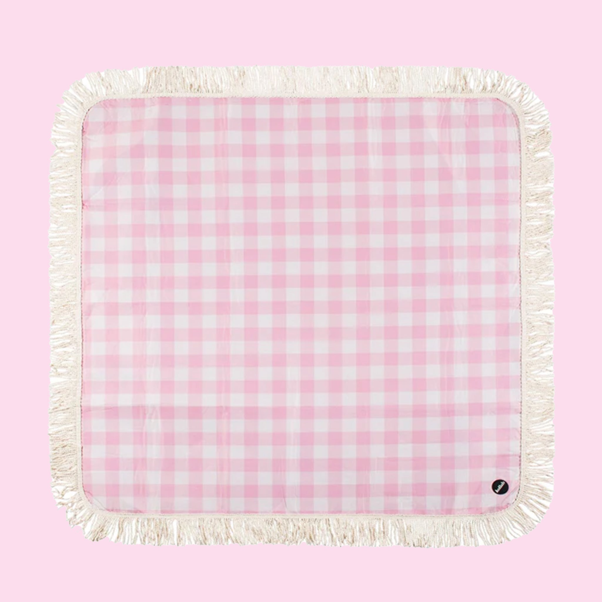A pink and white checkered picnic blanket with a fringe edge. 