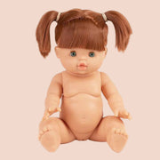 A baby doll with red hair in pigtails, green eyes and freckles.
