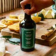 A bottle of olive oil with a green label that reads, 'Flamingo Estate Heirloom Garlic Extra Virgin Olive Oil'.