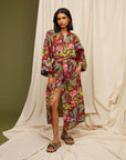 Brick red robe with colorful floral print is shown on a model.
