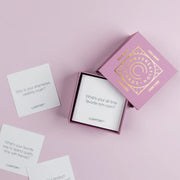 A pink box of conversation cards geared towards girls nights.