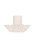 A cream glass taper candle holder with a wavy rim around the bottom.