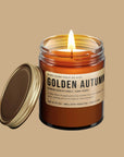 A dark brown glass jar candle with a brown label that reads, 'Golden Autumn'.