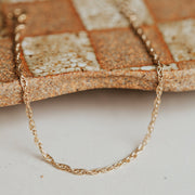 A gold chain bracelet.