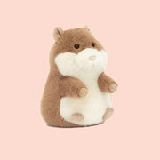 A tan and white stuffed animal guinea pig toy.