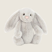 a grey bunny shaped stuffed animal.