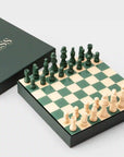A green and cream colored chess board set.