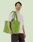 A vibrant green puffer tote bag.