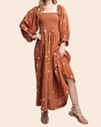 A rust / brown long-sleeve dress with flower embroidery.