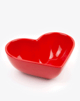A red ceramic heart shaped bowl.
