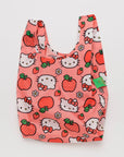 On a white background is a hello kitty and apple printed nylon tote bag.