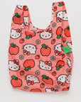 On a white background is a pink nylon bag with hello kitty and apple designs all over.