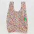 On a white background is a multi colored nylon bag with two handles and hello kitty icon graphics all over.
