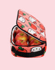 A pink and red lunch box with a Hello Kitty Apple pattern and black strap.