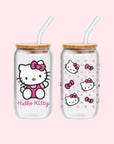 A set of two glass tumblers with hello kitty designs and glass straws.