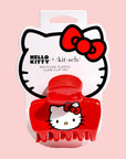 A red claw clip with a hello kitty fcae on the side.