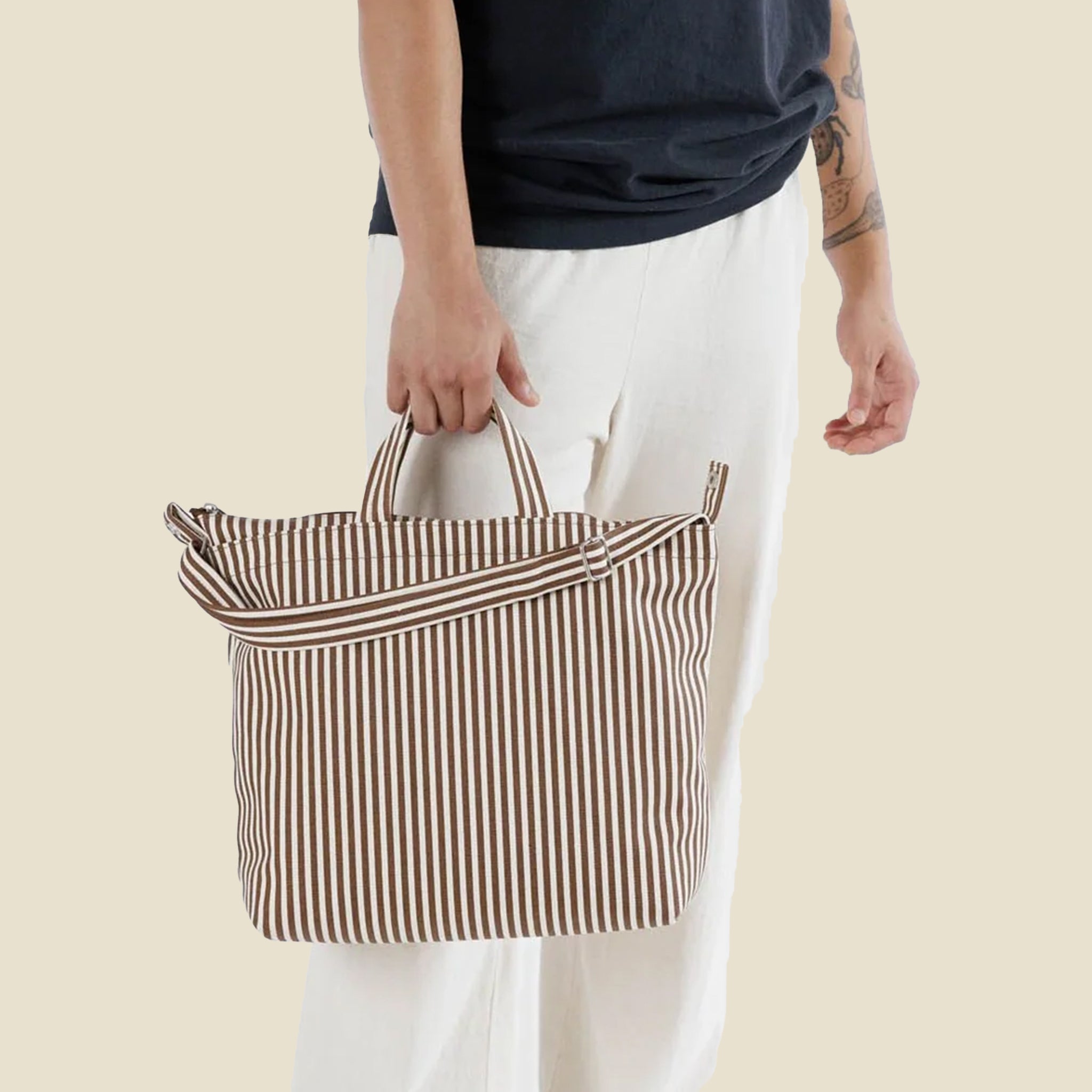A brown and ivory striped canvas tote bag with two different handle options.