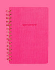 On a pink background is a hot pink spiral bound notebook with a soft cover and text in the center that reads, "Howdy" along with a pink and white horseshoe print on the inside cover.
