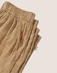 A pair of tan lounge pants with a scrunched waist band.