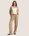 A pair of tan lounge pants with a scrunched waist band.