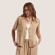 A tan short sleeved button up lounge shirt.