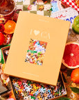 A puzzle box with the title, "I <3 CA" that has images of the iconic state of California including, green juices, sunglasses, animal style burgers and fries, tacos, a Hollywood street sign and more.