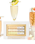 On a cream background is a set of three different flavored sugar cubes made for instant mimosa cocktails. The packaging reads, "Teaspressa Instant Mimosa Cocktail Kit".