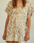 A gold sequin mini dress with short sleeves and a v-neck.