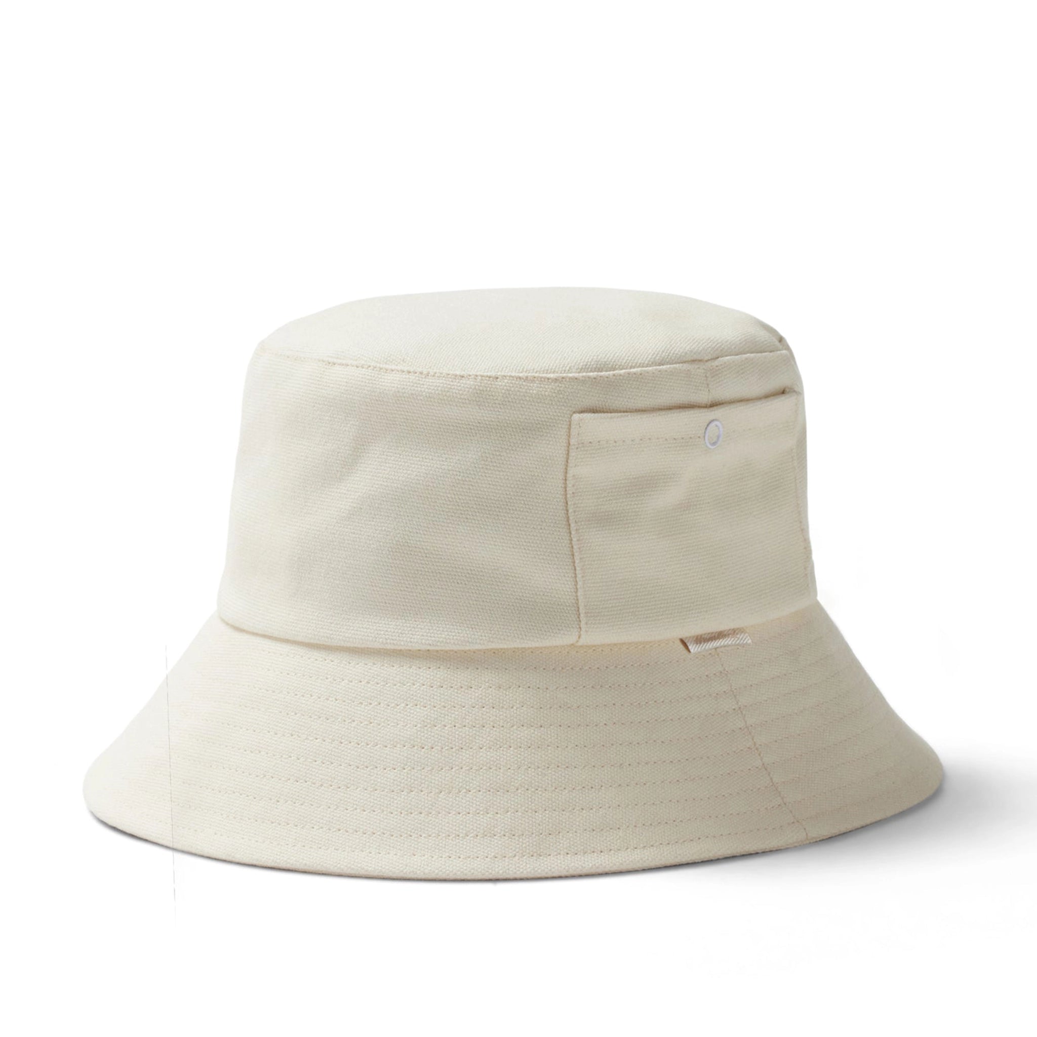 An ivory bucket hat with a small square pocket on the side.