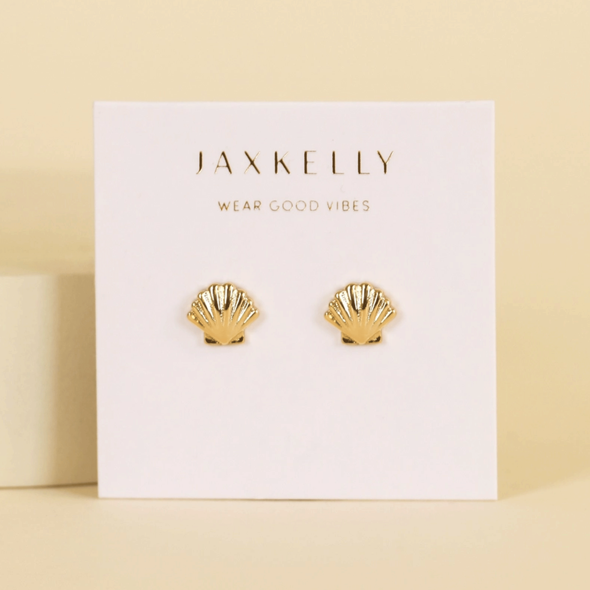 A pair of gold seashell shaped stud earrings. 