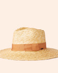 On a cream background is a light honey colored straw sun hat with a tan ribbon around the base.