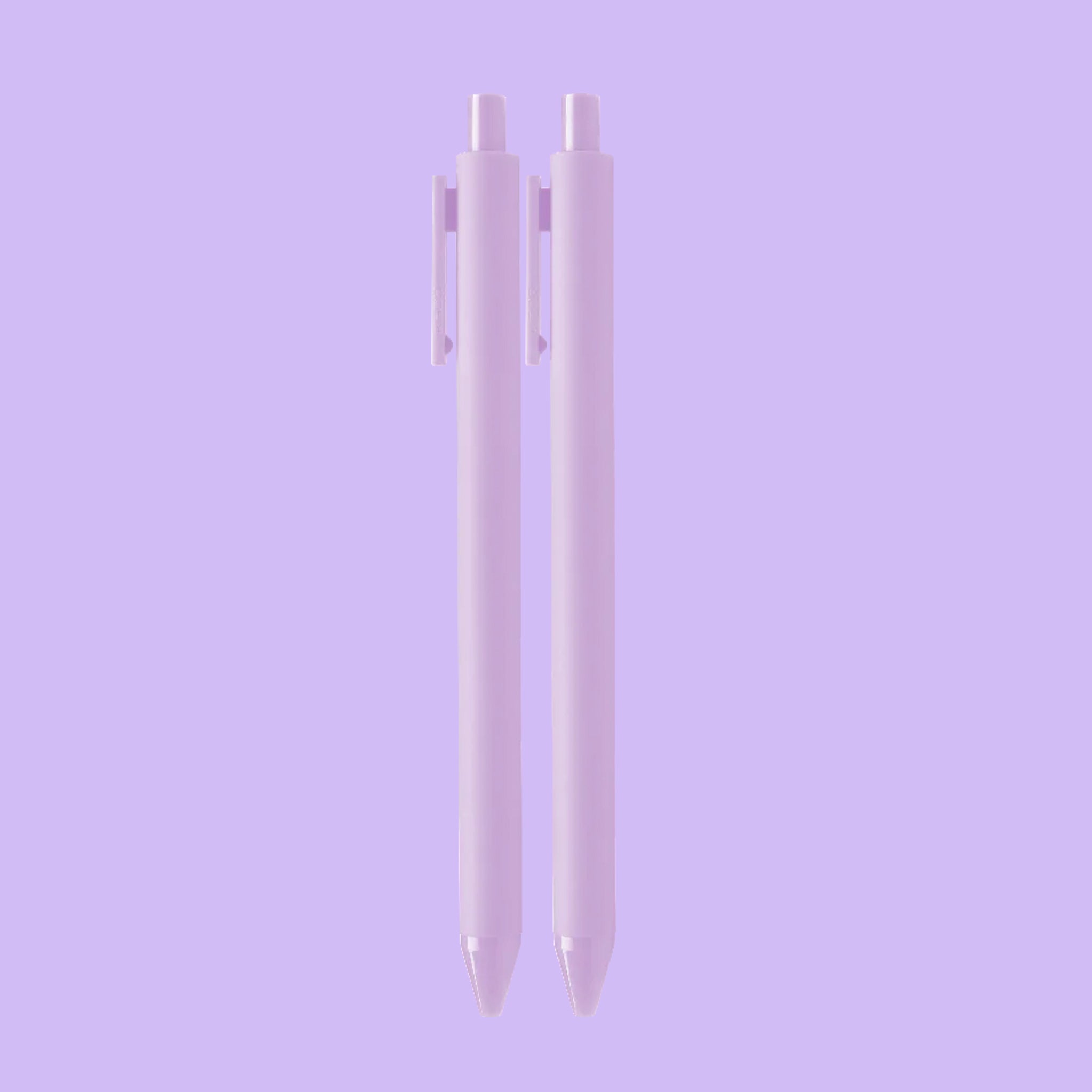 On a purple background is a set of two ballpoint pens with a light purple exterior. 