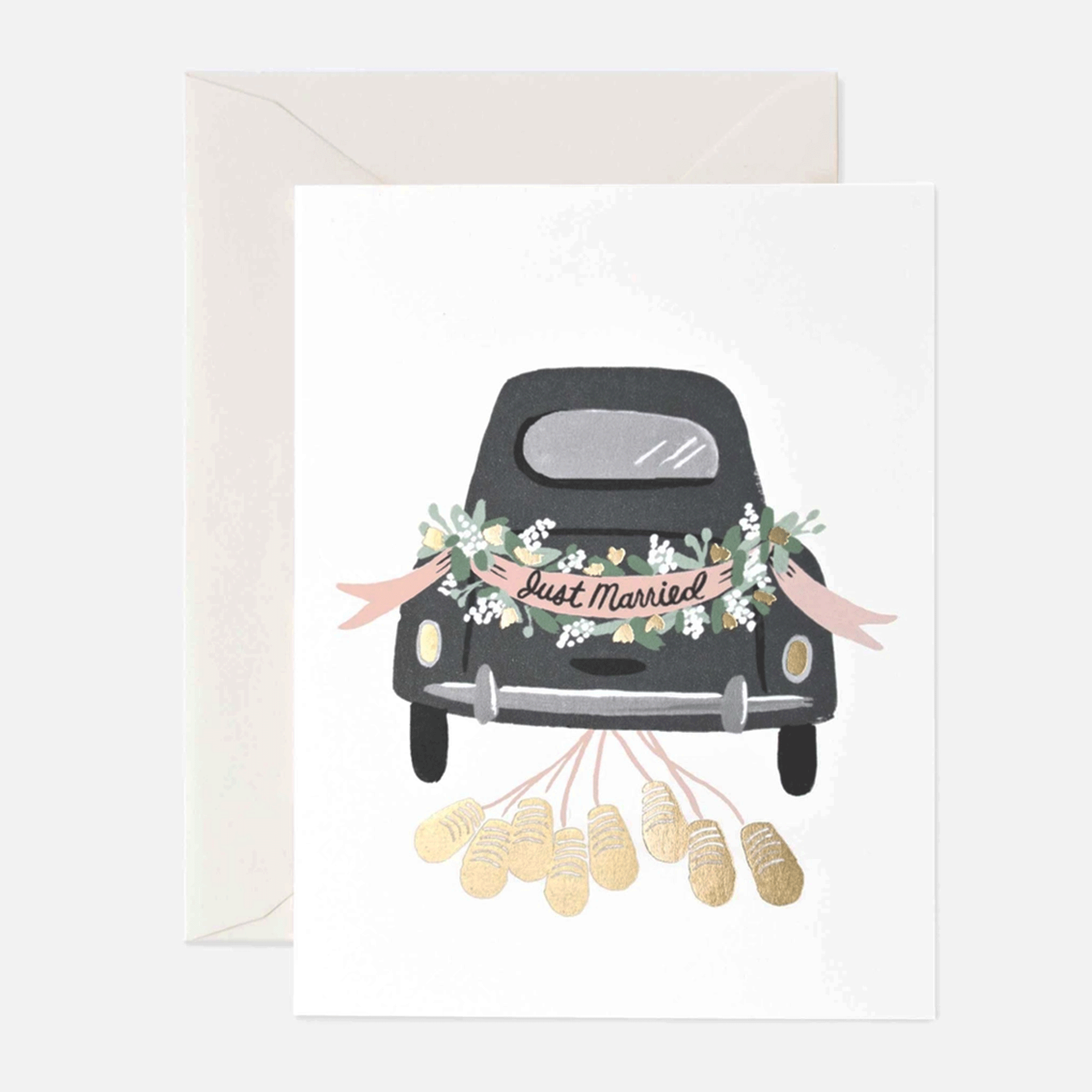 On a white background is a white card with a black getaway card decorated with a banner that reads, "Just Married" and greenery around it as well as gold foiled cans coming from the bottom of the car. 
