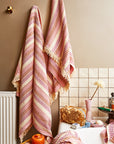 A pink striped waffle knit bath towel.