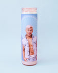 On a blue background is a blue prayer candle with a photo of Ken played by the actor Ryan Gosling.