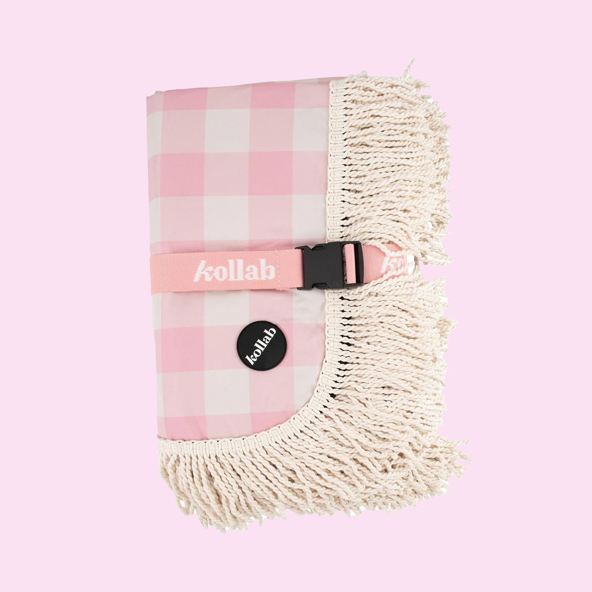 A pink and white checkered picnic blanket with a fringe edge.