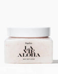 A clear container with a neutral body scrub inside, white lid and black text that reads, "La Vie Aloha".