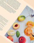 On a tan background is the book open to a page of the book with text on the left side and a colorful image of a fruit sorbet on the other.