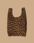 A small nylon tote bag in a leopard print that folds up into a small pouch.