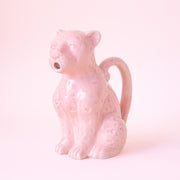 a ceramic pink, leopard shaped pitcher that could be used for kitchen use or plant watering.