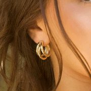 A model wearing the lil Bia hoop earrings featuring a hoop earring with three hoops combined together.