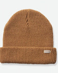 A tan ribbed beanie with a small rectangle label on the right corner that reads, "Brixton" on a white background.