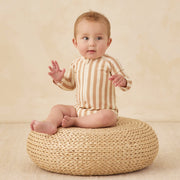 A cream and tan striped rashguard swimsuit for kids.