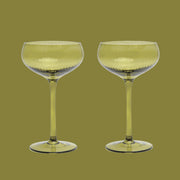 An olive green coupe glass.