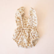 a neutral romper with a leopard print made for Minikane dolls.