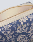detailed view of blue cosmetic pouch with white flower pattern